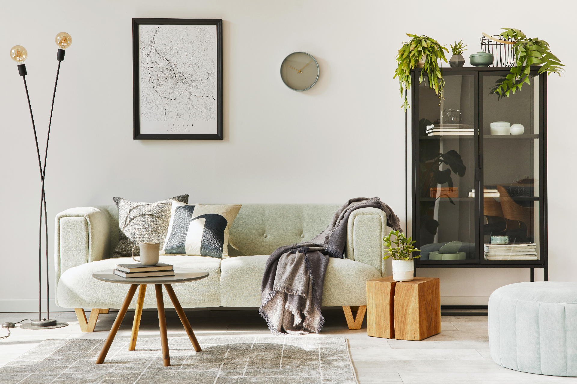 Bright, tidy living room with soft green sofa and natural light